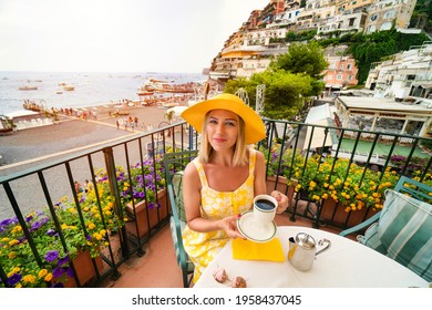 A Woman In Yellow Drinks Coffee At Café In Positano Amalfi Coast Italy.