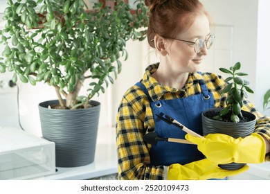 A woman in yellow gloves holds a trowel with soil, getting ready to plant flowers. Her lifestyle revolves around home gardening, nurturing plants and creating a green oasis indoors. - Powered by Shutterstock