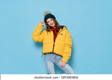 woman in yellow jacket fashionable clothes lifestyle blue background