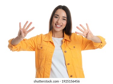 Woman in yellow jacket showing number eight with her hands on white background - Powered by Shutterstock