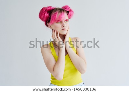 woman in a yellow shirt with pink hair