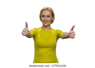 Woman In Yellow Showing Okay With Both Hands On White Background. Smiling Lady With Outstretched Arms.