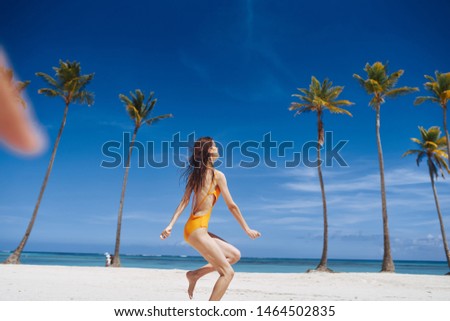 Woman in a yellow swimsuit beach tropics travel Exotic fun
