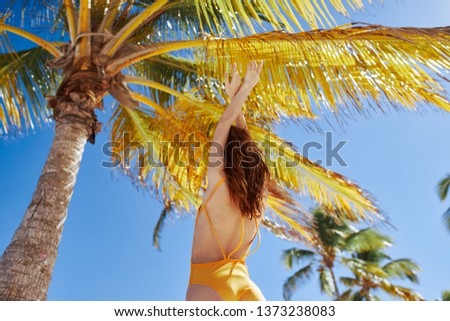 woman in yellow swimsuits for coconut relaxation relax exotic