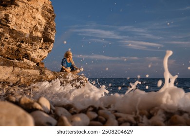 Woman Yoga Beach Ocean Sunset Meditation - A woman practices yoga on a rocky beach as the sun sets over the ocean. - Powered by Shutterstock