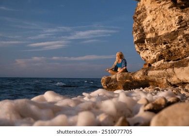 Woman Yoga Cliff Ocean - Woman practices yoga on a cliff overlooking the ocean with white foamy waves. - Powered by Shutterstock