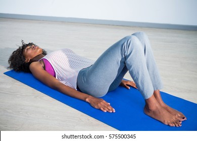 Woman In Yoga Corpse Pose In Gym