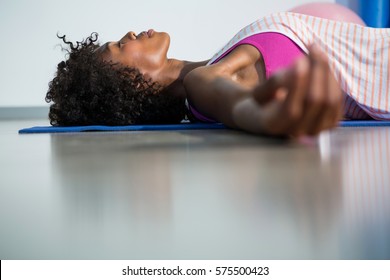Woman In Yoga Corpse Pose In Gym