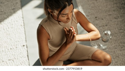 Woman, yoga and fitness with lotus pose on living room floor for zen, mental health and healthy in above. Indian, person or meditation in peace to relax, chakra train and spiritual wellness at home