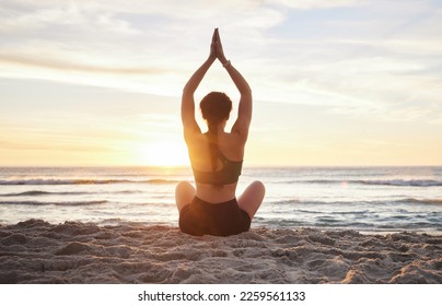 Woman, yoga and meditation on the beach sunset for zen workout or spiritual wellness outdoors. Female yogi relaxing and meditating in sunrise for calm, peaceful mind or awareness by the ocean coast