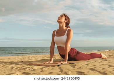 Woman in yoga pose on beach - serenity and mindfulness, harmonious connection with nature. - Powered by Shutterstock