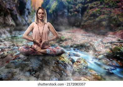 Woman Yoga Practitioner Meditating By A River In The Canyon