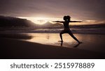 Woman, yoga and silhouette at beach for warrior pose at sunset with balance, peace and nature. Girl, person and outdoor for stretching by sea for meditation, mindfulness or health at dusk in Colombia