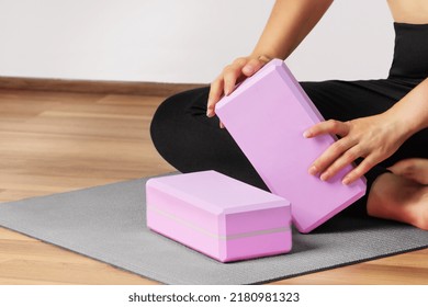 Woman yoga workout with yoga blocks on yoga mat indoor. Healthy lifestyle. - Powered by Shutterstock