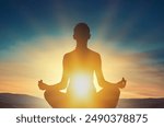 Woman young person in yoga pose meditation at sunset.