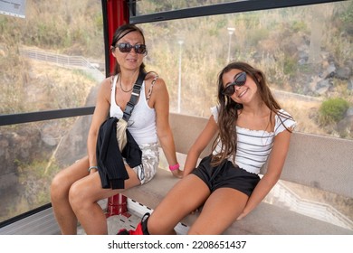 Womand And Daughter Happy Smiling Inside A Cable Car.