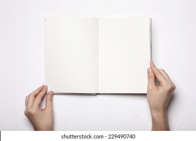 A Woman(female) Two Hands Hold A Empty(blank) Book(note, Diary) Spread(unfold) Isolated White, Top View, Studio.