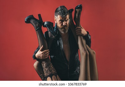 Womanizer. Bearded Brutal Man With Female Legs In Sexy Pantyhose. Seductive Sensual Relationship. Passion And Polygamy. Fashion And Beauty. Pimp And Model Agent. Man And Two Women, Seductive Legs