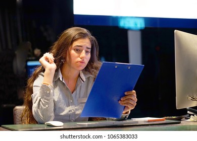 A Woman-reception Hotel Worker Reading Negative News In Letter. Shocked Beauty Girl Business Manager Received Layoff Message Letter From Company Feeling Surprised. An Agitated Girl Without Joy.