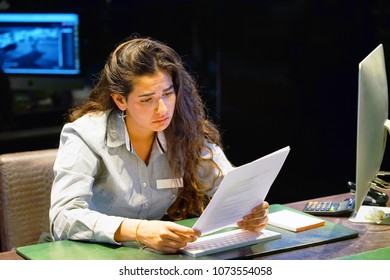 A Woman-reception Hotel Worker Reading Negative News In Letter. Shocked Beauty Girl Business Manager Received Layoff Message Letter From Company Feeling Surprised. An Agitated Girl Without Joy.