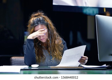 A Woman-reception Hotel Worker Reading Negative News In Letter. Shocked Beauty Girl Business Manager Received Layoff Message Letter From Company Feeling Surprised. An Agitated Girl Without Joy.