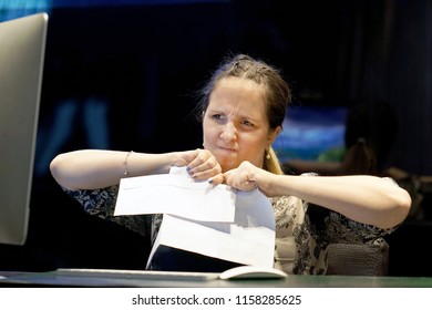 A Woman-reception Hotel Worker Tear The Letter Negative News. Shocked Beauty Girl Business Manager Received Layoff Message Letter From Company Feeling Surprised. An Agitated Girl Without Joy.