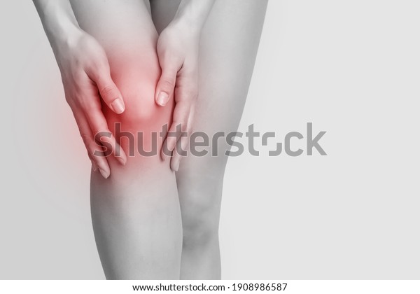 a woman\'s bad knee, a red source of knee pain\
on a gray background copy\
spatio