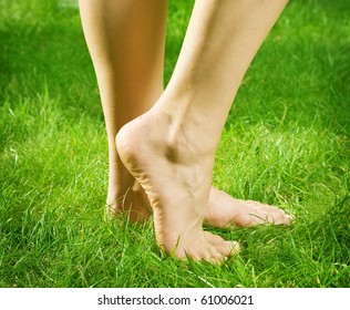 Woman's Bare Feet In Green Grass