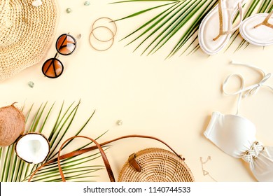 Woman's Beach Accessories: Bikini, Rattan Bag, Straw Hat, Tropical Palm Leaves On Yellow Background. Summer Background. Flat Lay, Top View.