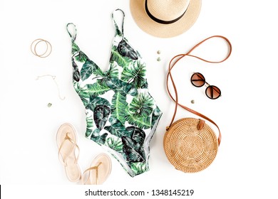 Woman's Beach Accessories: Swimsuit With Tropical Print, Rattan Bag, Straw Hat On White Background. Summer Background. Flat Lay, Top View.