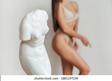 A woman's body near gypsum sculpture