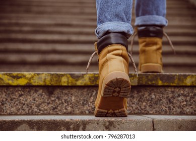 Womans Boots Close Up Climb Up By Old Stairs