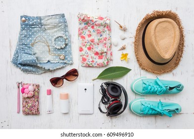 Woman's Casual Summer Clothes With Accessories Items On White Rustic Wooden Board Background, Overhead Top View, Flay Lay