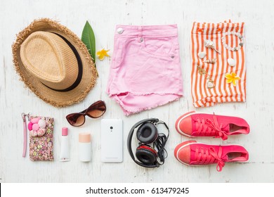 Woman's Casual Summer Clothes With Accessories Items On White Rustic Wooden Board Background, Overhead Top View, Flay Lay