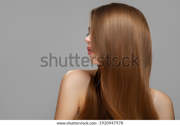 Woman\'s clean styled hair. Half of the face is\
covered with brunette\
hair