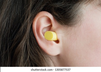 Woman's ear with an ear plug, noice  reduce, noice pollution .