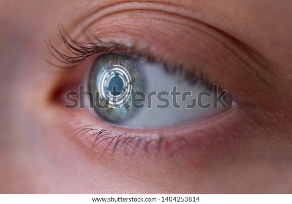 Woman\'s eye with smart contact lens\
with digital and biometric implants to scan the ocular retina close\
up. Concept of future and technology for digital\
scans