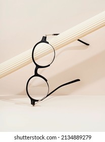 Woman's Eyeglasses On Light Background. Flat Lay, Top View. Black Glasses. The Product Still Life Concept.