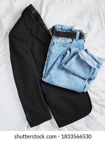 Woman's Fall Outfit With Black Oversized Blazer And Vintage Mom Jeans Isolated On White Linen Background. Flat Lay. Top View