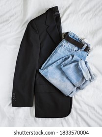 Woman's Fall Outfit With Black Oversized Blazer And Vintage Mom Jeans Isolated On White Linen Background. Flat Lay. Top View