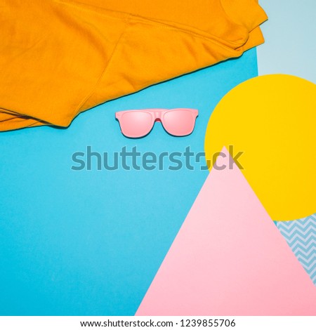 Woman's fashion set of  pink sunglasses and yellow pullover on memphis style background. Geometry minimal concept. Fall and winter  