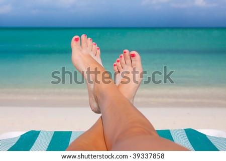 Womans feet on the beach