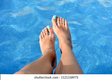 
Woman's feet in the pool