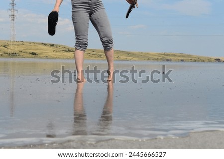 Woman's feet in a salt lake