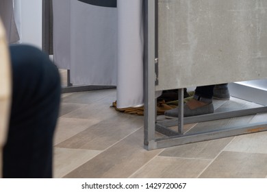 Woman's Feet Seen At Changing Room In An Apparel Or Clothing Store. 