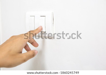A woman's finger is pressing a switch and copy space