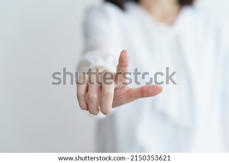 Woman's fingertips trying to touch