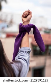WOMAN'S FIST WITH FEMINIST SCARF IN MARCH PROTEST MARCH MARCH 8 ABORTION FIGHT AGAINST PATRIARCHY