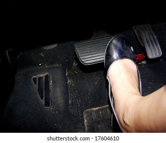 A Woman's Foot Depressing The Brake Pedal Of A Sportscar.