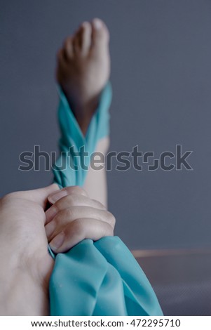 Woman's foot with elastic band performing stretching exercise